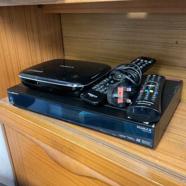 Black Humax freesat receiver with remote control for digital TV.