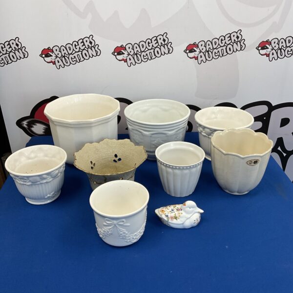 White ceramic plant pots and a duck dish for home decor.