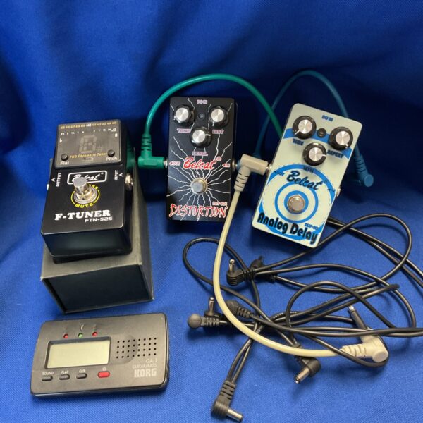 Vintage guitar pedals including Belcat distortion and Korg tuner.