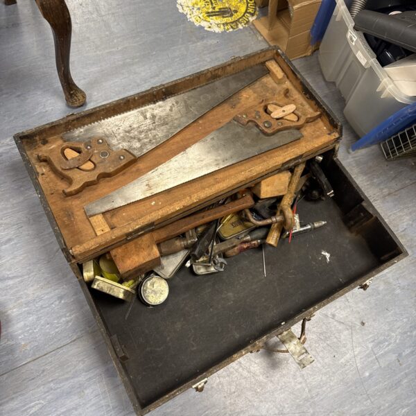 Vintage carpenter's toolbox filled with antique woodworking tools.