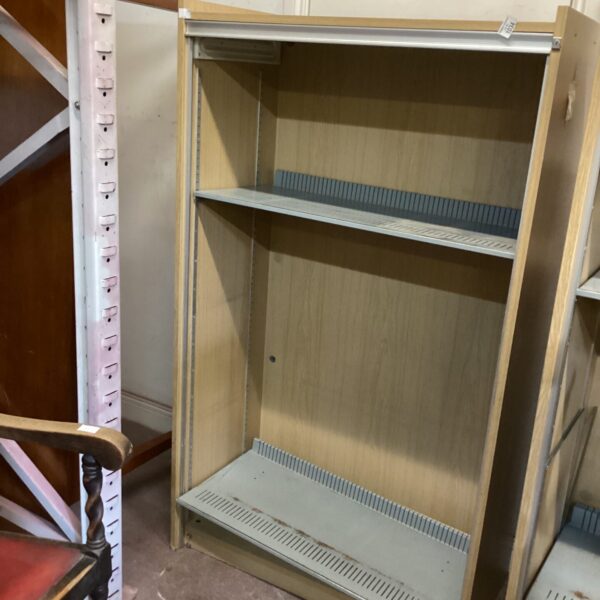 Tall pine shelving unit with multiple open shelves.