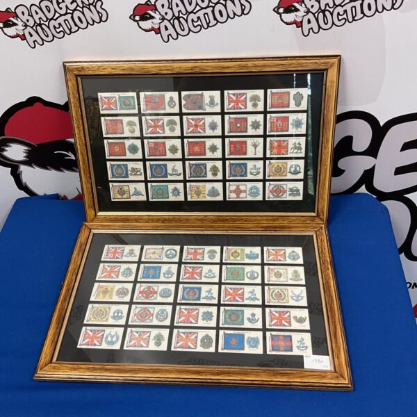 Framed vintage military badge cigarette cards for collectors.