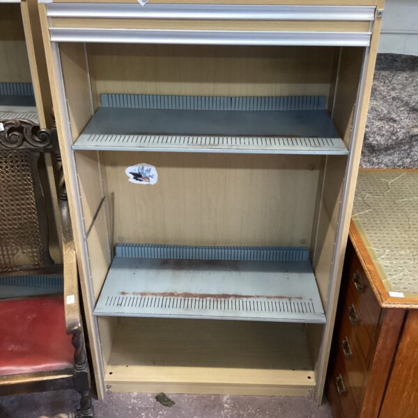 Vintage wooden filing cabinet with sliding door.