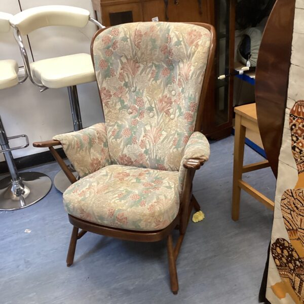 Vintage Ercol armchair with patterned fabric upholstery.