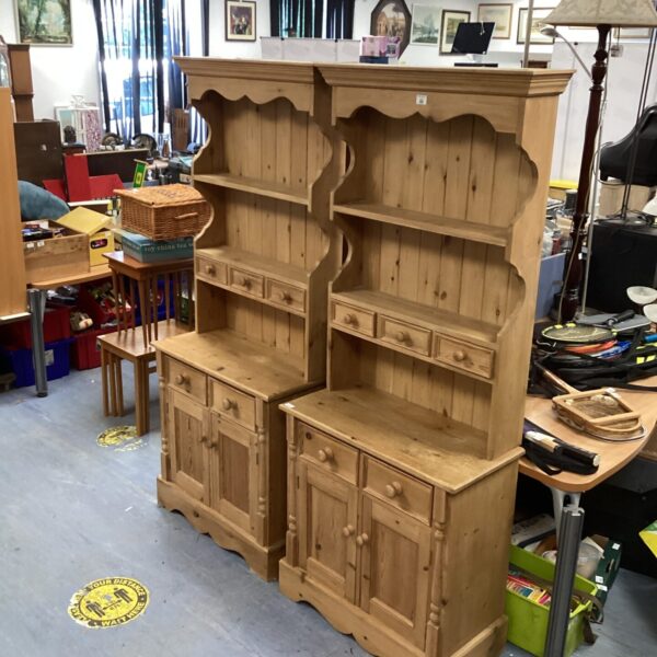 Pair of vintage pine Welsh dressers in a showroom setting.