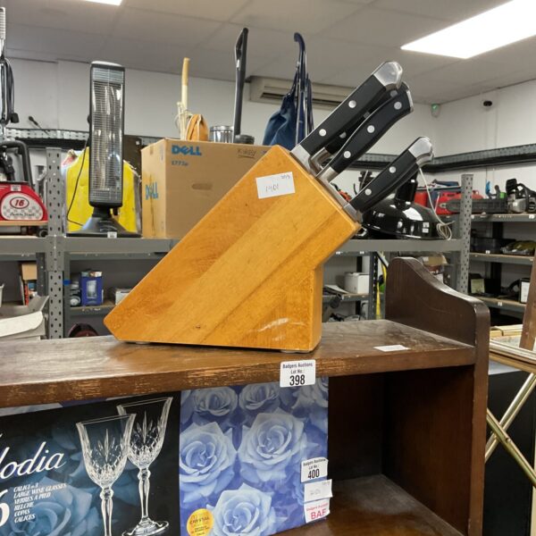 Wooden kitchen knife block set with stainless steel knives.
