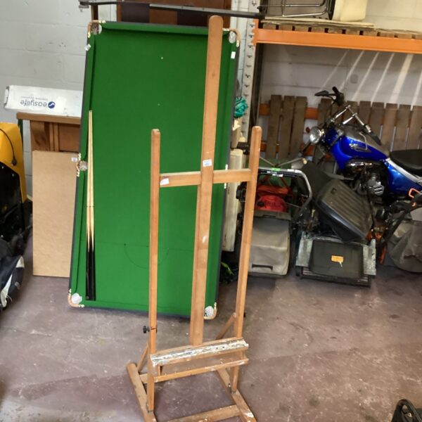 Front view of a vintage wooden artist easel.