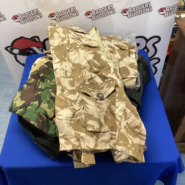 British military clothing lot with camouflage coat, shirts and polo shirt.