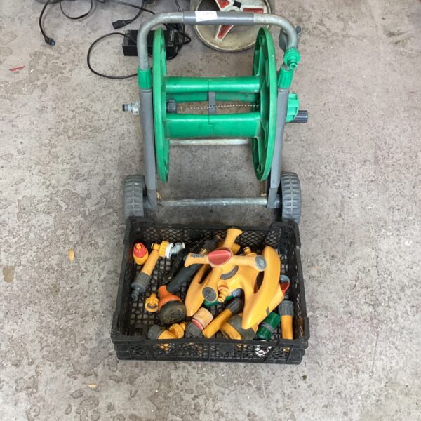 Hozelock garden hose reel with various watering accessories.