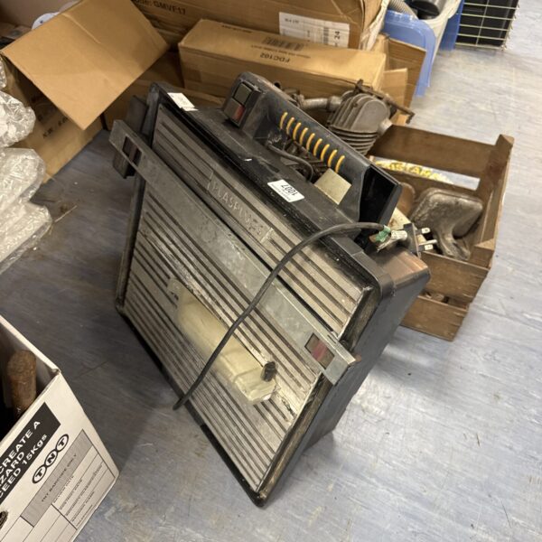 Used Plasplugs electric tile cutter for DIY tiling projects.