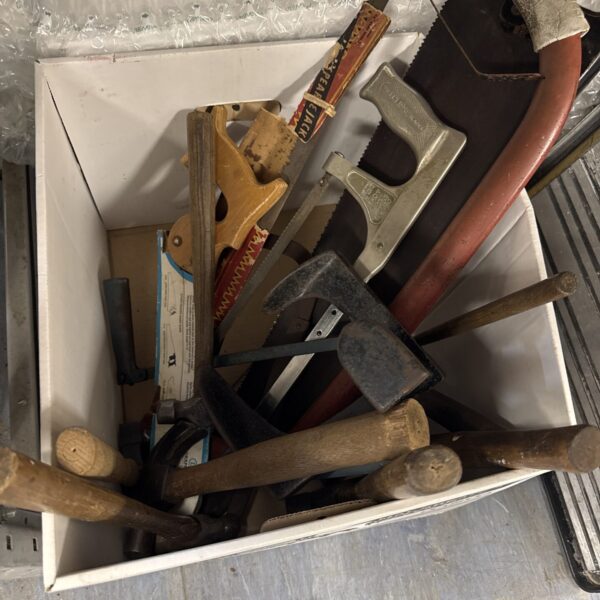 Vintage hand tool lot including saws and other implements.