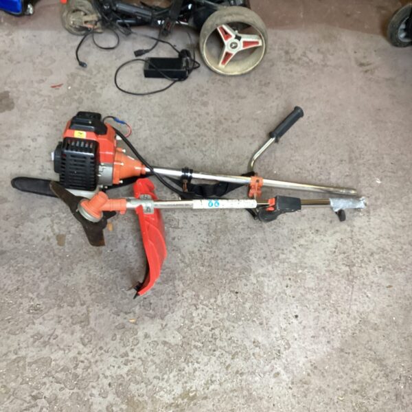 Side view of a used petrol bush cutter for garden maintenance.