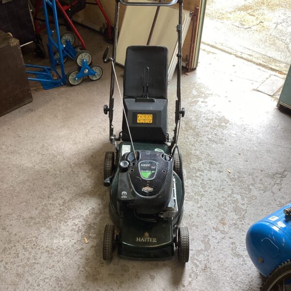 Hayter Motif petrol lawn mower in a garage setting.