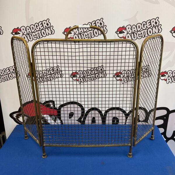 Vintage brass tri-fold firescreen for fireplace safety and style.