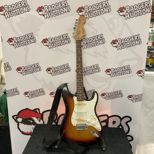 Sunburst Fender Squire Strat electric guitar, detailed view.