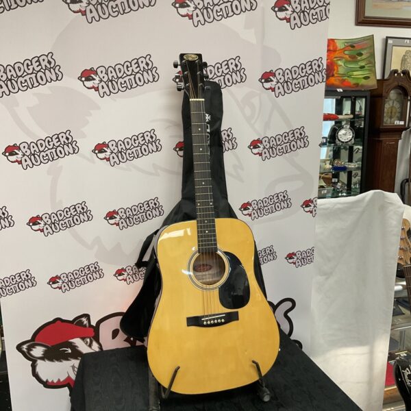 Handmade Stagg SW203W western acoustic guitar in light wood finish.