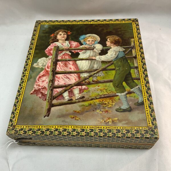 Antique Edwardian puzzle block featuring children by a fence.