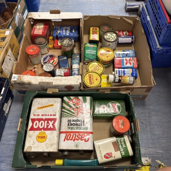 Vintage garage tins and workshop containers, collectible automotive ephemera.