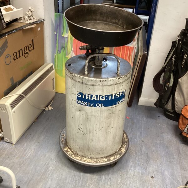 Vintage car oil changer unit on wheels for garage use.