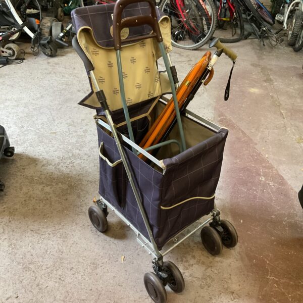 Blue Sholley shopping trolley with walking sticks for mobility.