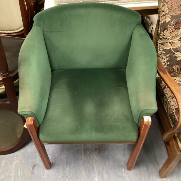 Vintage green tub chair with wooden legs.