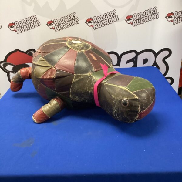 Side view of a colourful retro turtle footrest.