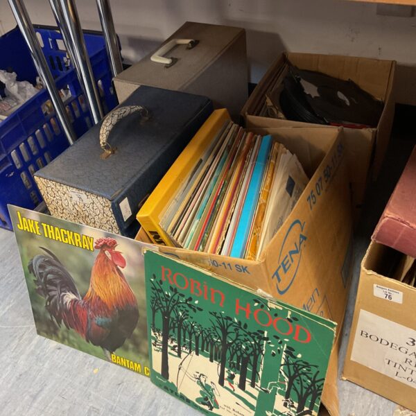 Close-up of vinyl record cover art in a lot of records.