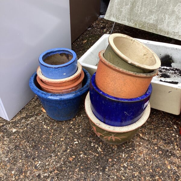 Collection of colourful garden pots for plants and outdoor decor.