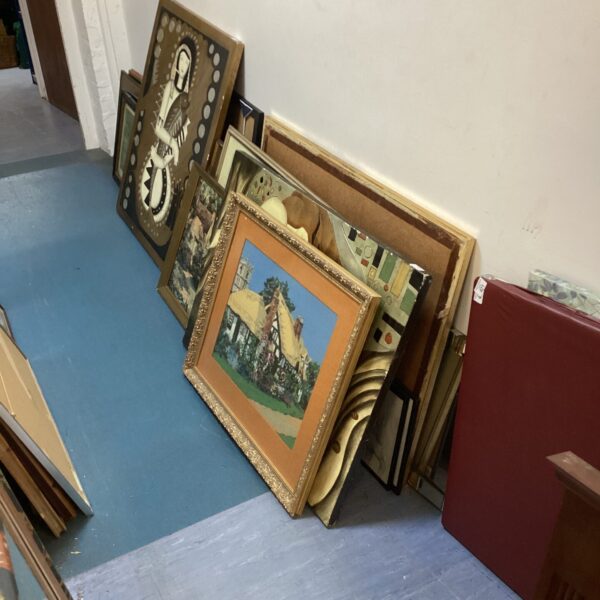 Mixed artwork lot featuring various framed paintings and art pieces.