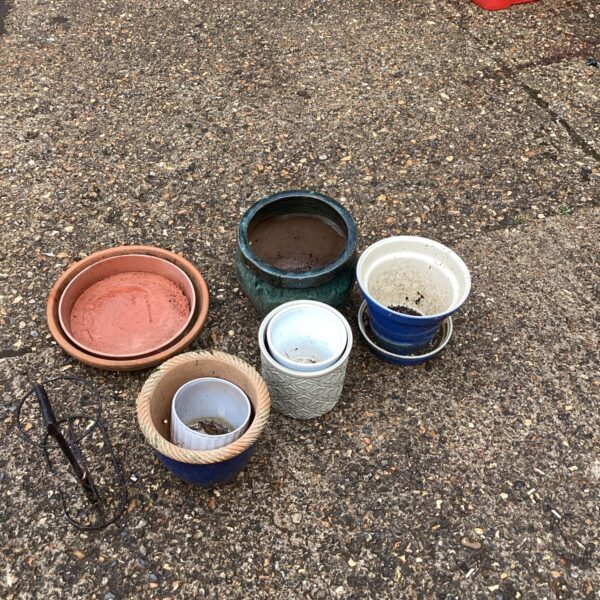 Assortment of vintage garden pots and planters for outdoor use.