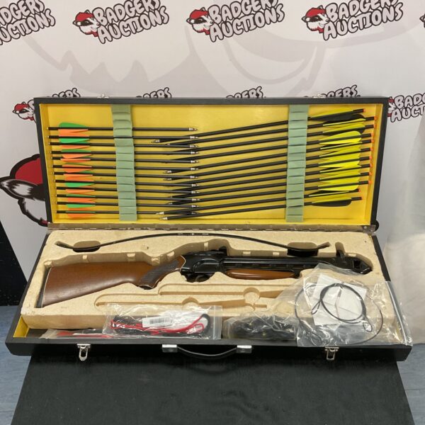 Vintage crossbow with case and arrows for archery or display.