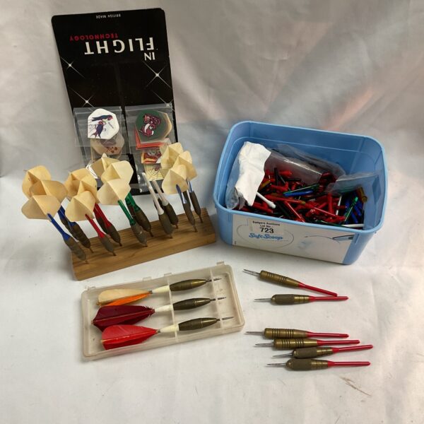 Close-up of a vintage dart set with various flights.