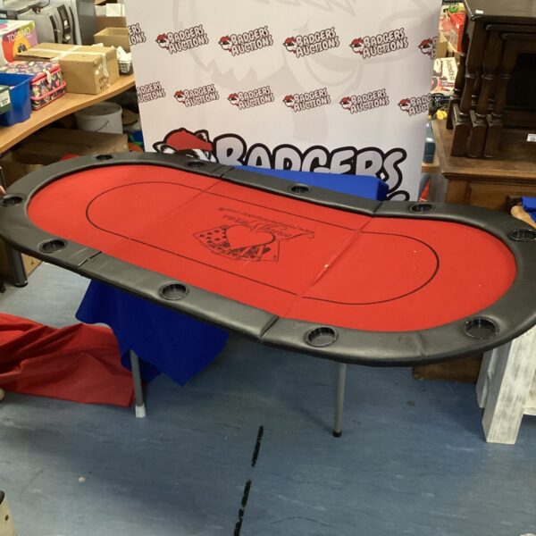 Green felt round poker table top for card games.