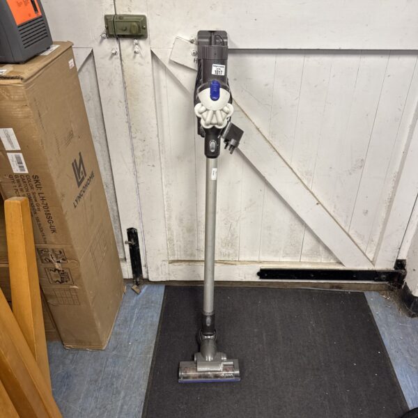 Dyson V8 cordless vacuum cleaner with charger, ready for use.