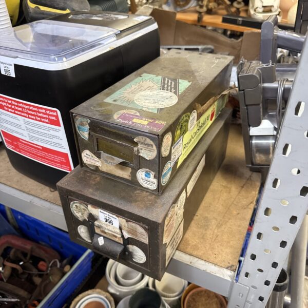 Front view of vintage metal filing drawers with wear.