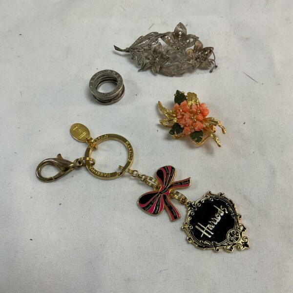 Harrods keyring and vintage silver and coral brooches collection.