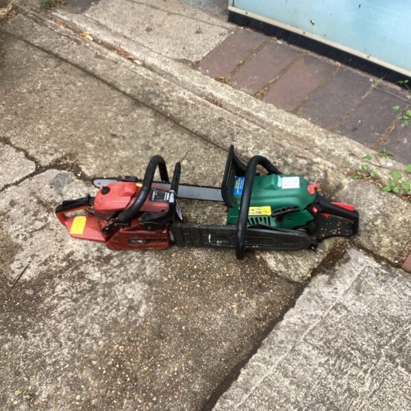 Red and black McCulloch petrol chainsaw needing repair for garden work.