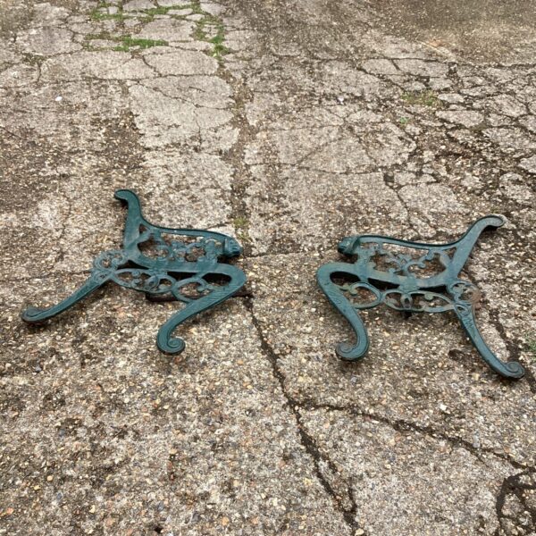 Intricate Victorian cast iron bench ends for garden furniture restoration.
