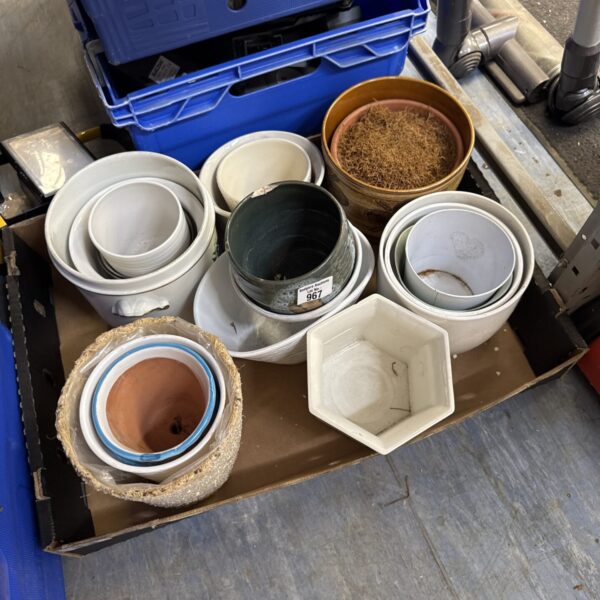 Mixed lot of assorted plant pots for gardening.