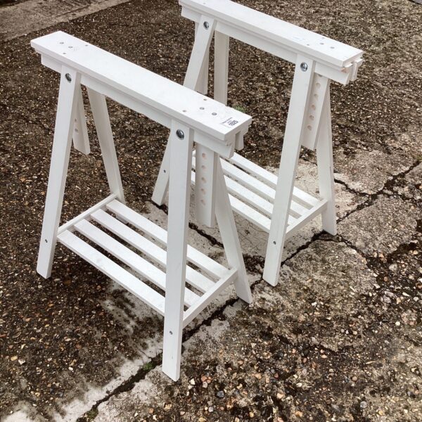 White trestle table set for events and workshops.