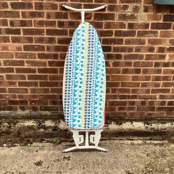 Colourful vintage ironing board with geometric pattern.