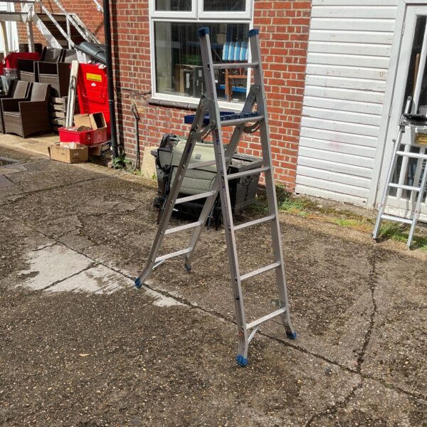 Silver Werner abru combination ladder with work platform.