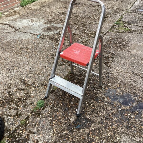 Small aluminium step ladder, folded and ready for use.