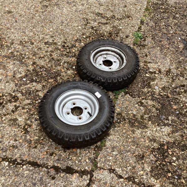 Pair of used trailer wheels and tyres for off-road use.