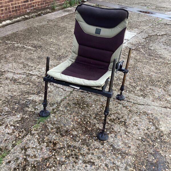 Close-up of a folding fishing chair in an outdoor setting.