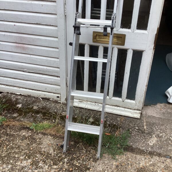 Silver aluminium loft ladder leaning against a wall.
