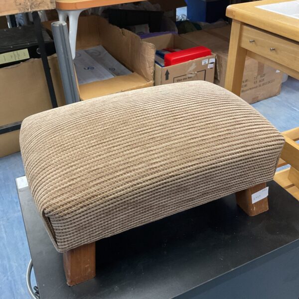Vintage brown corduroy footstool for comfortable seating.