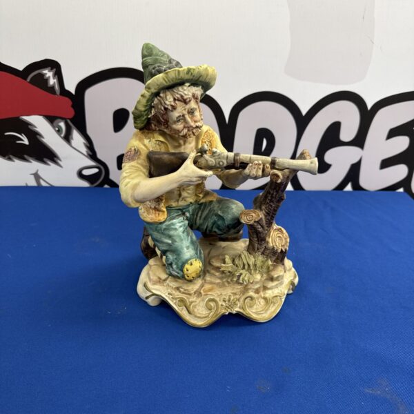 Antique Capo Di Monte figurine of a gentleman with a blunderbuss.