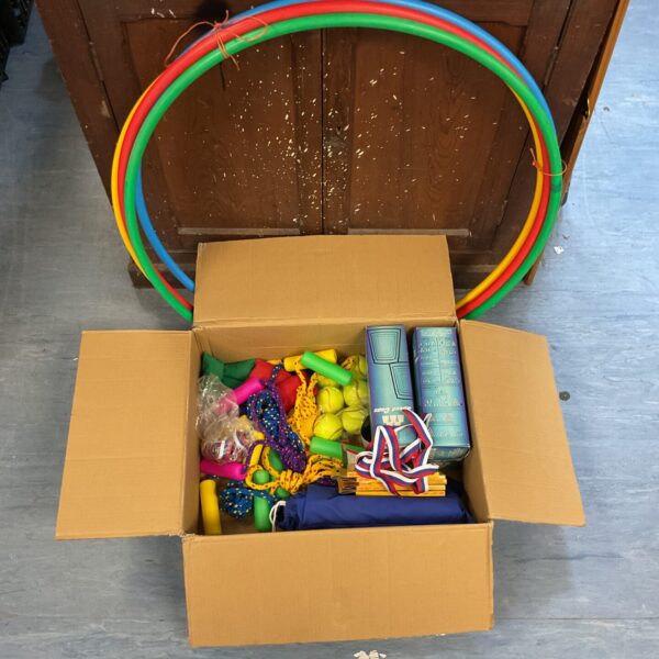Brightly coloured hula hoops and skipping ropes in an outdoor games bundle.