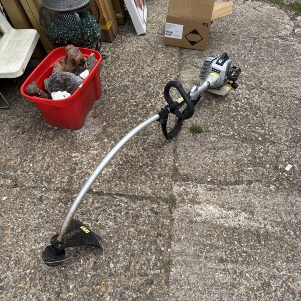 Used Spear & Jackson petrol strimmer for garden maintenance.